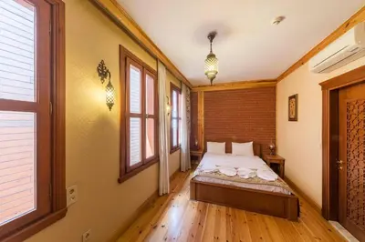 a bedroom with a bed and two windows at Lalinn Hotel in Istanbul