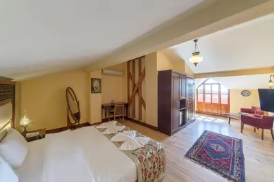 a hotel room with a bed and a living room at Lalinn Hotel in Istanbul