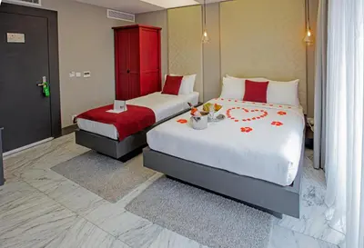 a bedroom with two beds and a red cabinet at Nowy Efendi Hotel - Special Category in Istanbul