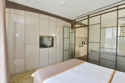 a bedroom with a bed and a tv on the wall at Upsuites Hotel in Istanbul