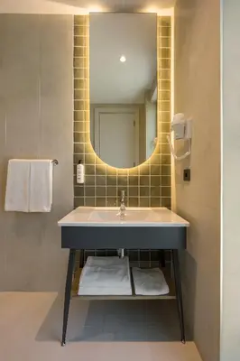a bathroom with a sink and a mirror at Upsuites Hotel in Istanbul