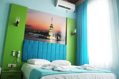 a bedroom with a bed with a painting on the wall at HOTEL MİKLAGORD in Istanbul
