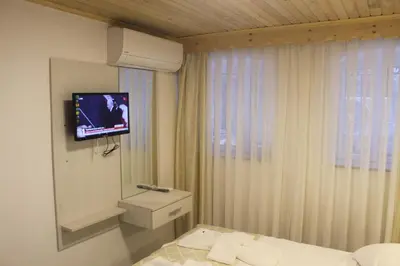 a hotel room with a bed and a tv on the wall at HOTEL MİKLAGORD in Istanbul