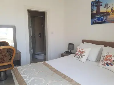 a bedroom with a bed with white sheets and pillows at Zeugma Hotel Sultanahmet in Istanbul