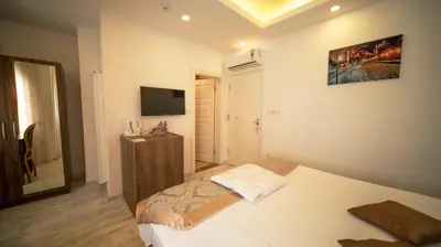 a small bedroom with a bed and a television at Zeugma Hotel Sultanahmet in Istanbul