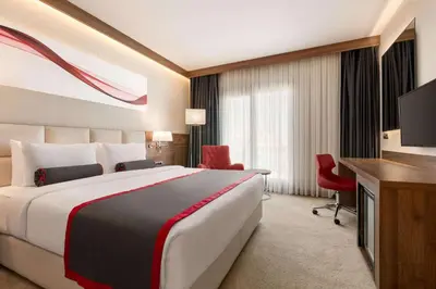 a hotel room with a large bed and a television at Ramada by Wyndham Beylikduzu in Istanbul