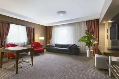 a living room with a couch and a table at Ramada Plaza By Wyndham Izmit in Kocaeli
