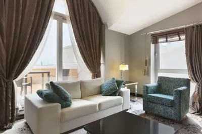 a living room with a couch and a chair at Ramada Plaza By Wyndham Izmit in Kocaeli