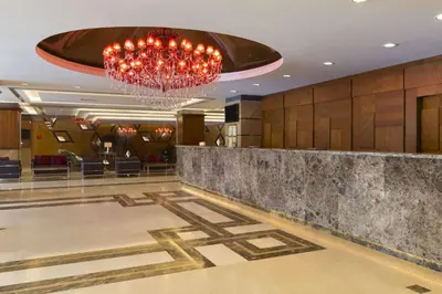 a hotel lobby with a chandelier and a dance floor at Ramada Plaza By Wyndham Izmit in Kocaeli