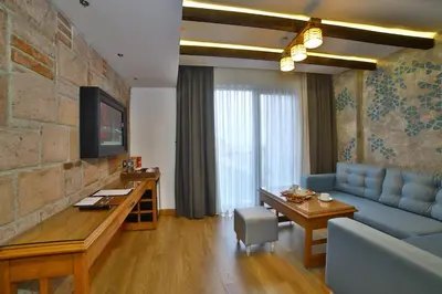 a living room with a blue couch and a table at Yılsam Sultanahmet Hotel in Istanbul