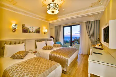 a hotel room with two beds and a television at Yılsam Sultanahmet Hotel in Istanbul