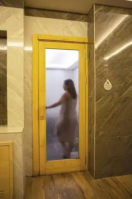 a woman standing behind a door in a room at Premier Vista Hotel in Silivri