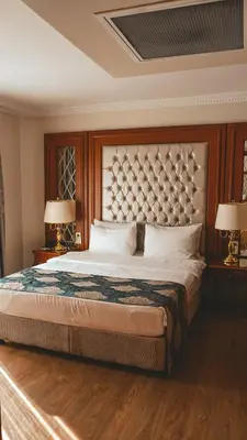 a bedroom with a large bed with two lamps at Premier Vista Hotel in Silivri