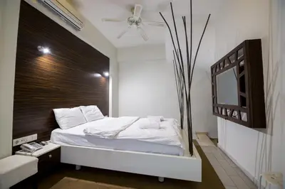 a bedroom with a white bed and a mirror at Element Suites in Istanbul