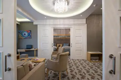 a living room with a couch and a chandelier at The Berussa Hotel in Bursa