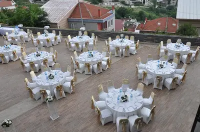 a group of tables and chairs with white tables and chairs at The Berussa Hotel in Bursa