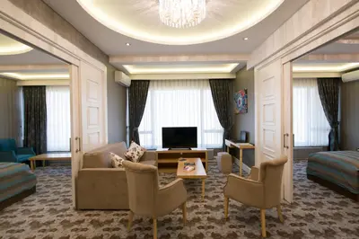 a hotel room with a couch and a tv at The Berussa Hotel in Bursa