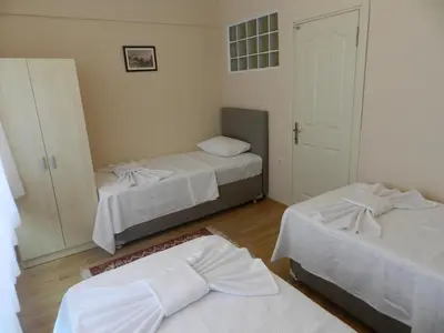 a room with two beds and a closet with a door at Hagia Sophia Apartment in Istanbul