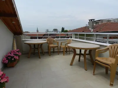 a patio with tables and chairs on a balcony at Hagia Sophia Apartment in Istanbul