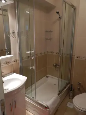 a bathroom with a shower and a tub and a sink at Hagia Sophia Apartment in Istanbul