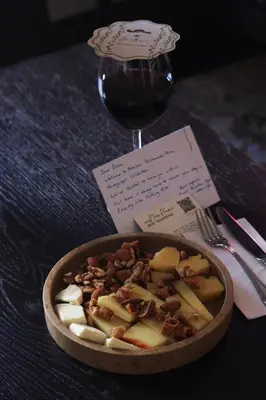 a bowl of food next to a glass of wine at Adahan DeCamondo Pera, Autograph Collection in Istanbul