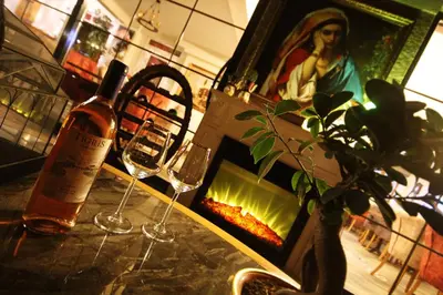 two wine glasses sitting on a table next to a fireplace at Lagun Palas in Yalova
