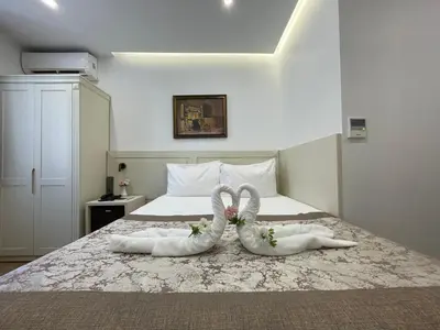 two people in white towels laying on a bed at Gul Hotel in Istanbul