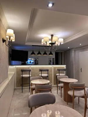 a restaurant with tables and chairs and a bar at Gul Hotel in Istanbul