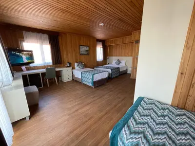 a hotel room with two beds and a desk at Gul Hotel in Istanbul