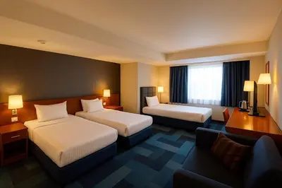 a hotel room with two beds and a couch at Taxim Express Bosphorus Hotel in Istanbul
