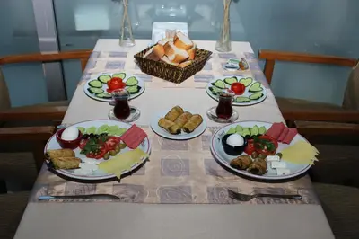 a table with four plates of food on it at Anka Premium Hotel in Istanbul
