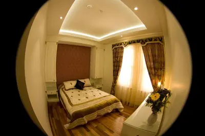 a bedroom with a bed and a window at Ersari Hotel in Istanbul