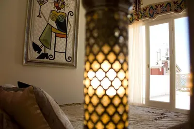 a vase in a room with a window and a painting at Ersari Hotel in Istanbul
