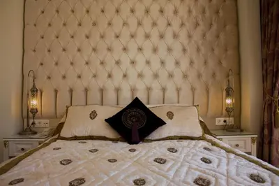 a bedroom with a large bed with a large headboard at Ersari Hotel in Istanbul