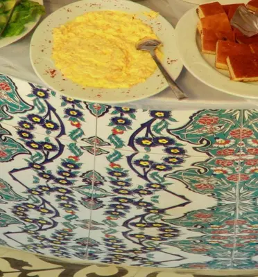 a table with a plate of food and a plate of fruit at Ersari Hotel in Istanbul