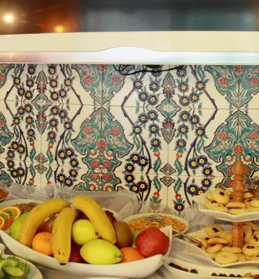 a bunch of fruits and vegetables in bowls on a shelf at Ersari Hotel in Istanbul