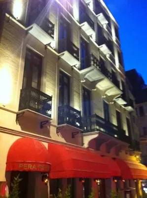 a building with a red awning in front of it at Pera Residence in Istanbul