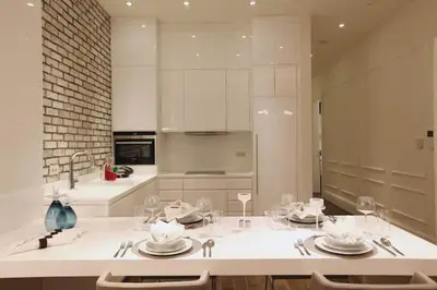 a kitchen with a table with plates and wine glasses at Pera Residence in Istanbul