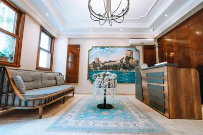 a living room with a couch and a painting on the wall at Gulliver Mansion Hotel in Istanbul