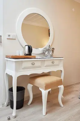 a white dressing table with a mirror and a stool at Mataraci Konak in Istanbul