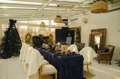 a long blue table with chairs and a christmas tree at Lale Hotel in Sapanca