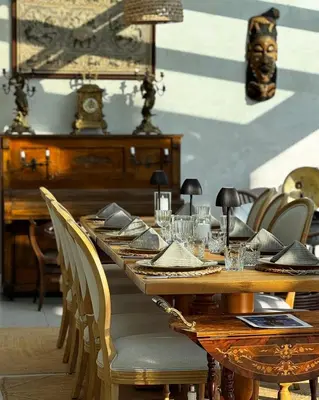 a long wooden table with chairs and a clock at Lale Hotel in Sapanca