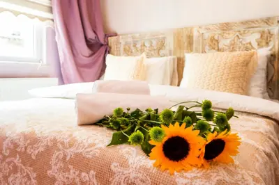 a bed with a bouquet of sunflowers on it at Ajda Haus Nisantasi in Istanbul