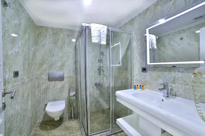a bathroom with a shower and a sink and a toilet at Monaco Hotel in Istanbul