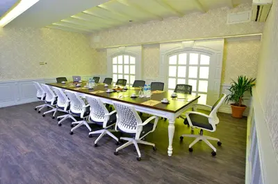 a large conference room with a long table and chairs at Monaco Hotel in Istanbul