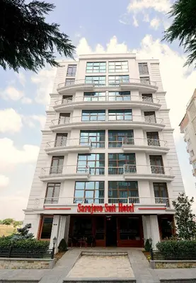 a tall white building with a sign on it at Sarajevo Suit Hotel in Kocaeli