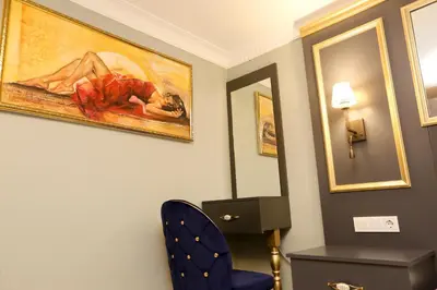 a room with a chair and a painting on the wall at Grand Moon Hotel Suites in Istanbul