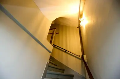 a hallway with stairs with a light on the wall at Grand Moon Hotel Suites in Istanbul