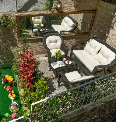 two wicker chairs and a table in a garden at Royan Suites in Istanbul
