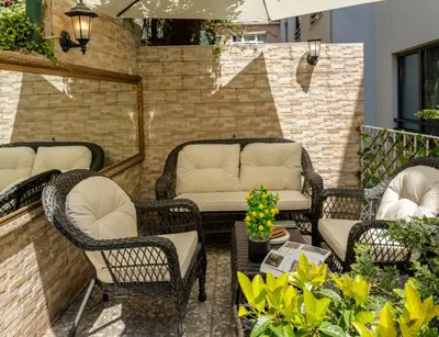 a patio with wicker chairs and a couch at Royan Suites in Istanbul